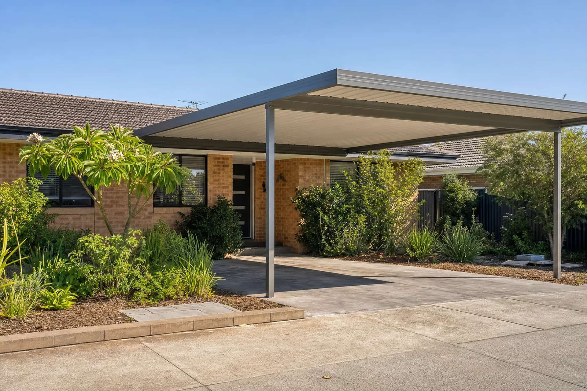 Colorbond carport matched to the roofline of a single-storey brick and tile home in Beldon