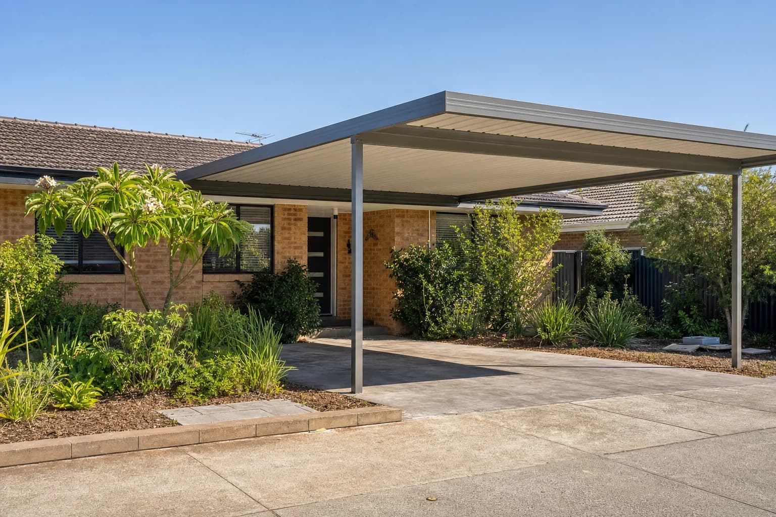 Colorbond carport matched to the roofline of a single-storey brick and tile home in Beldon
