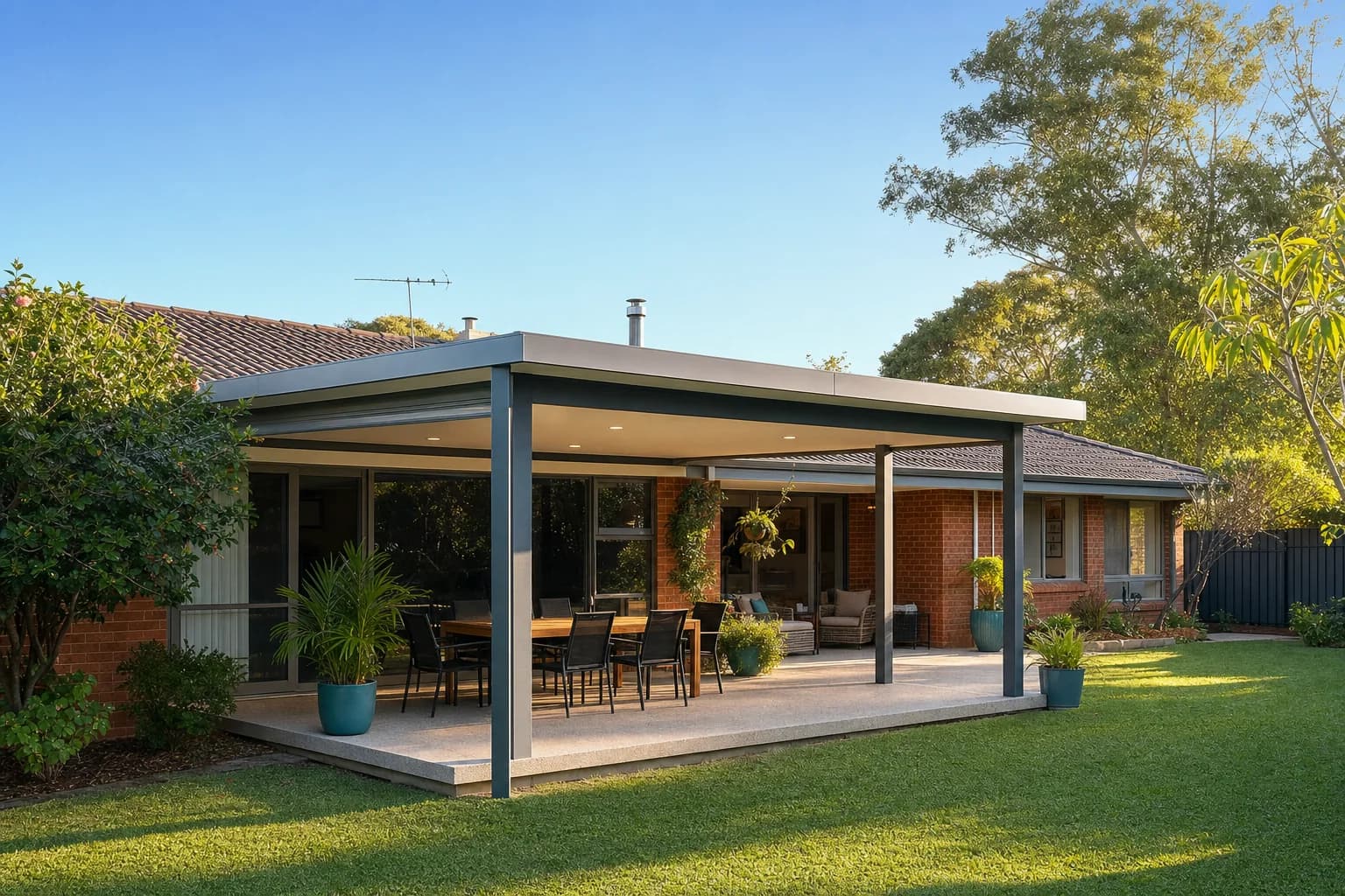 Freestanding flat roof patio behind a single-storey brick and tile home in Heathridge