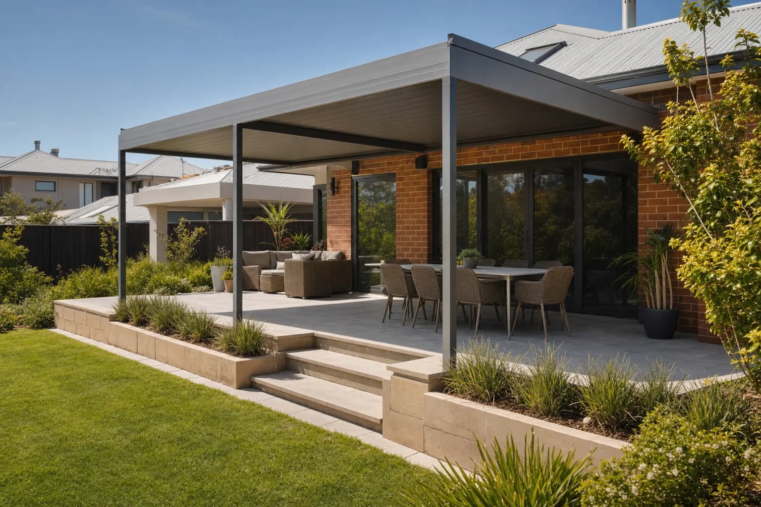 Stepped Colorbond patio on a sloping block behind a double-storey home in Kallaroo