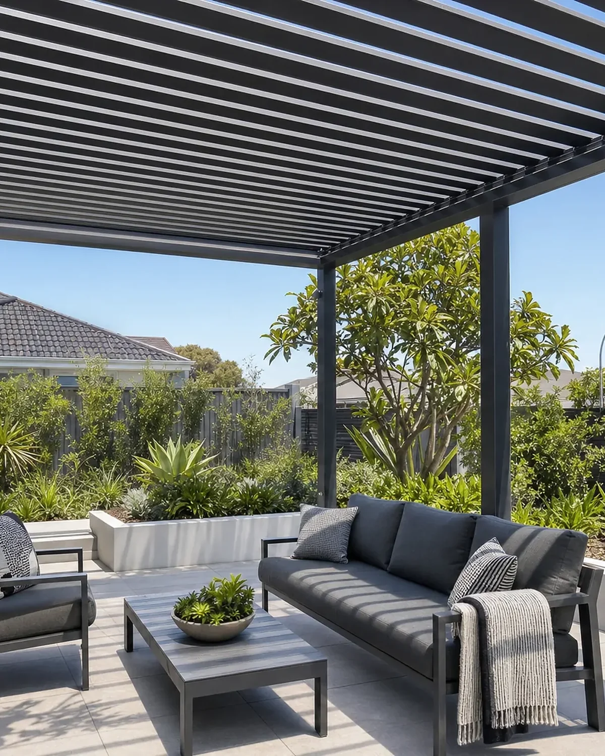 Open slatted aluminium pergola over an outdoor lounge in Joondalup